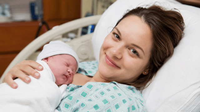 having a baby mother holding her newborn baby shortly after birth in a hospital room