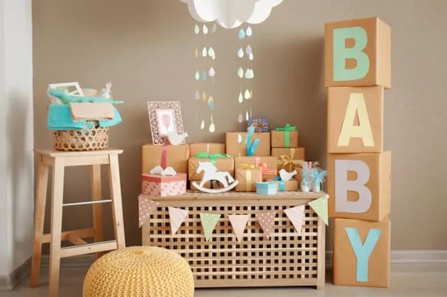 baby shower decorations with gifts, pastel colors and baby themed party setup for celebrating pregnancy