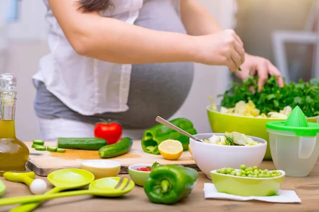 Pregnant woman preparing healthy pregnancy food