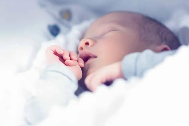 new parent tips with newborn baby sleeping peacefully at home