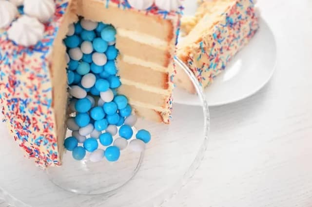 gender reveal ideas with cake filled with blue candies for baby announcement