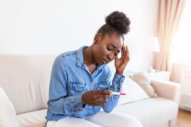 get pregnant fast concern with woman holding negative pregnancy test feeling worried