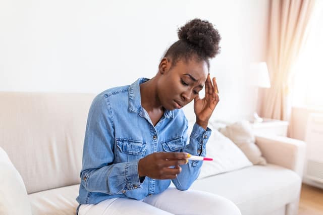 get pregnant fast concern with woman holding negative pregnancy test feeling worried