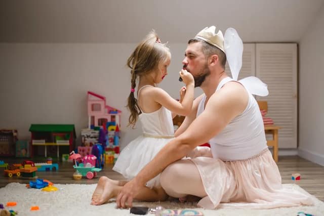 Father and daughter playing together to illustrate different parenting styles