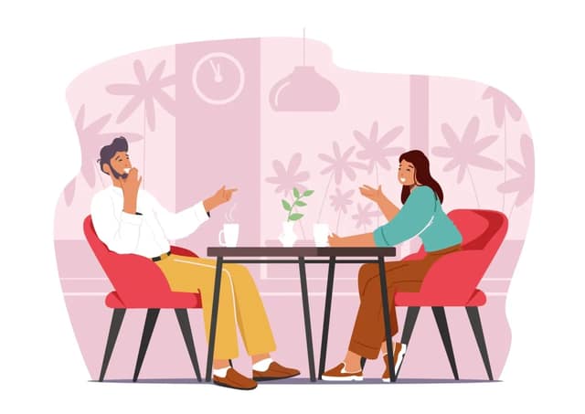 Man and woman on a casual date talking over coffee in a café
