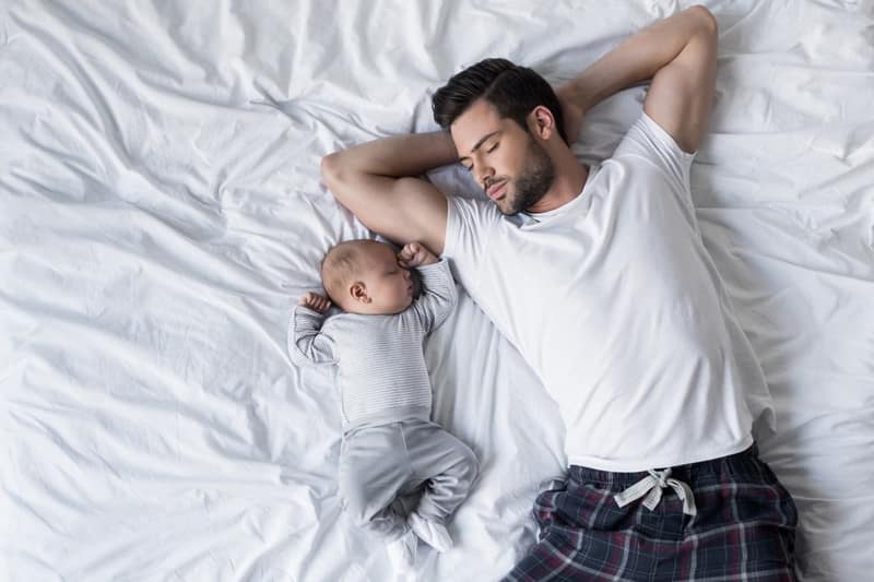 father sleeping with baby