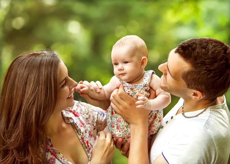 Parents with baby in a park — Co-parenting Guide illustration