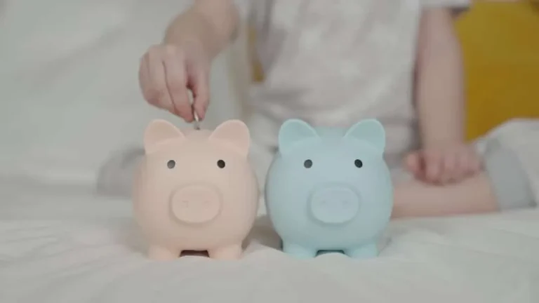 Child putting coins into piggy banks illustrating the cost of raising a child