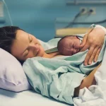 Register birth UK mother holding newborn baby in hospital