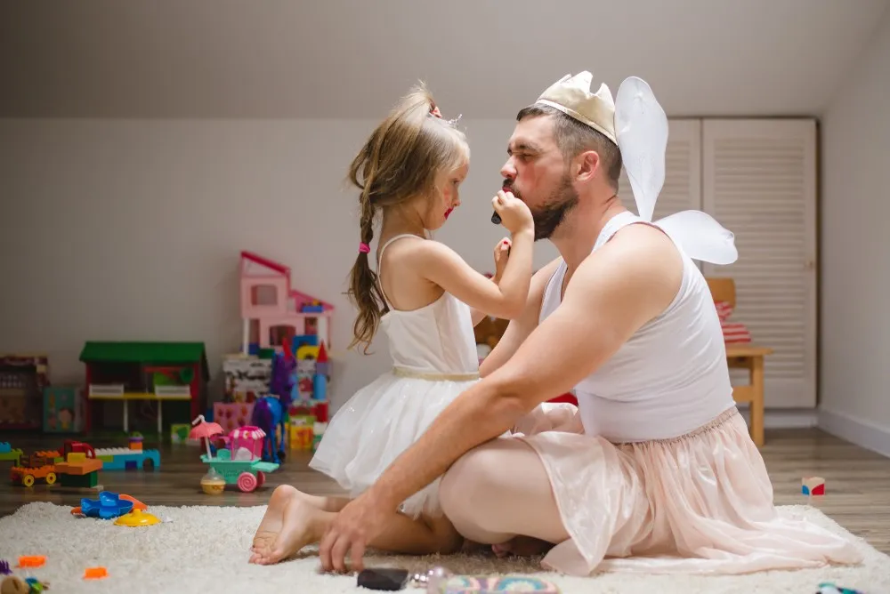 Father and daughter playing together to illustrate different parenting styles