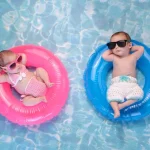 boy or girl baby concept with two infants in pink and blue floats