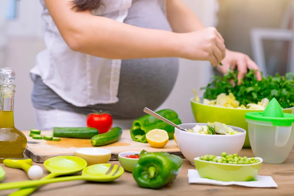 Pregnant woman preparing healthy pregnancy food