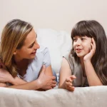 Donor conceived child talking with mother at home