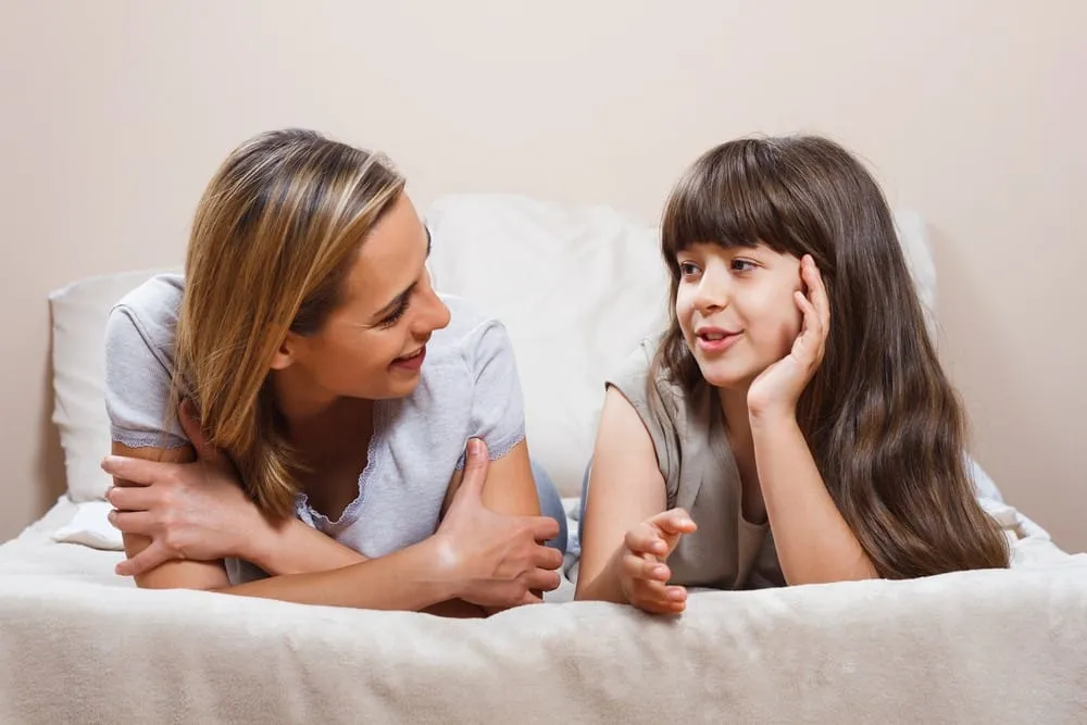 Donor conceived child talking with mother at home