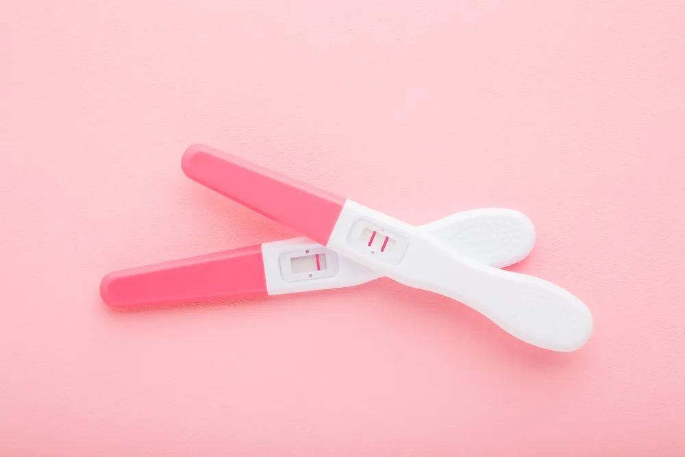 Conceive with donor sperm concept with positive pregnancy test showing two lines