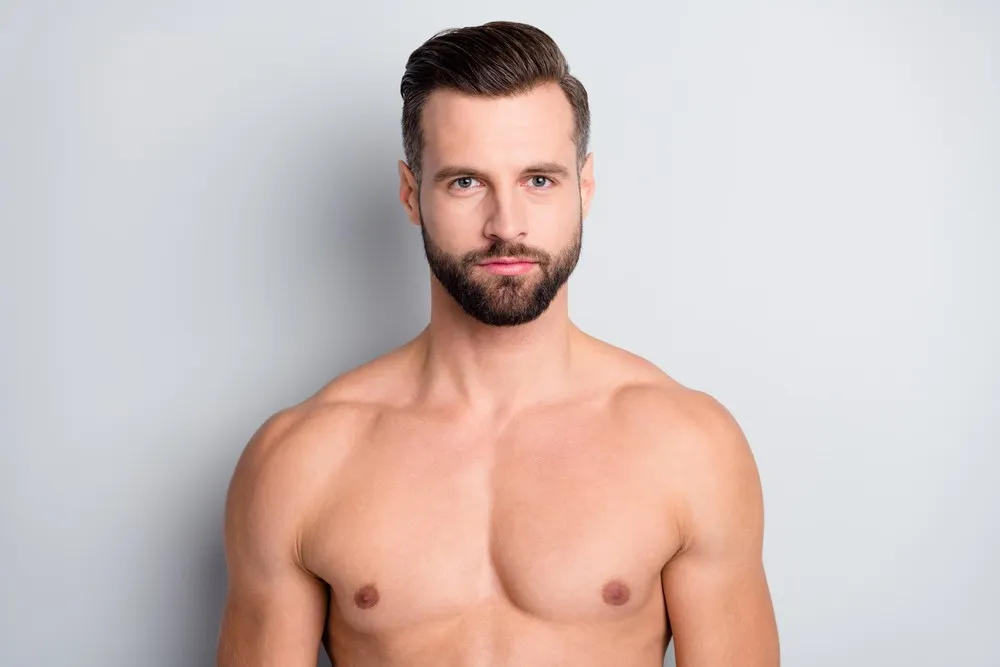 Close portrait of attractive well-groomed man with serious expression representing potential sperm donor candidate for fertility program